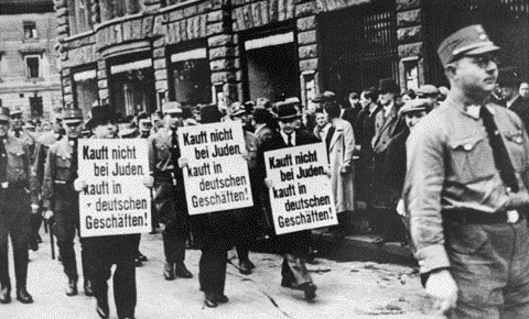 Jews Forced to
Carry
Anti-Semitic
Signs